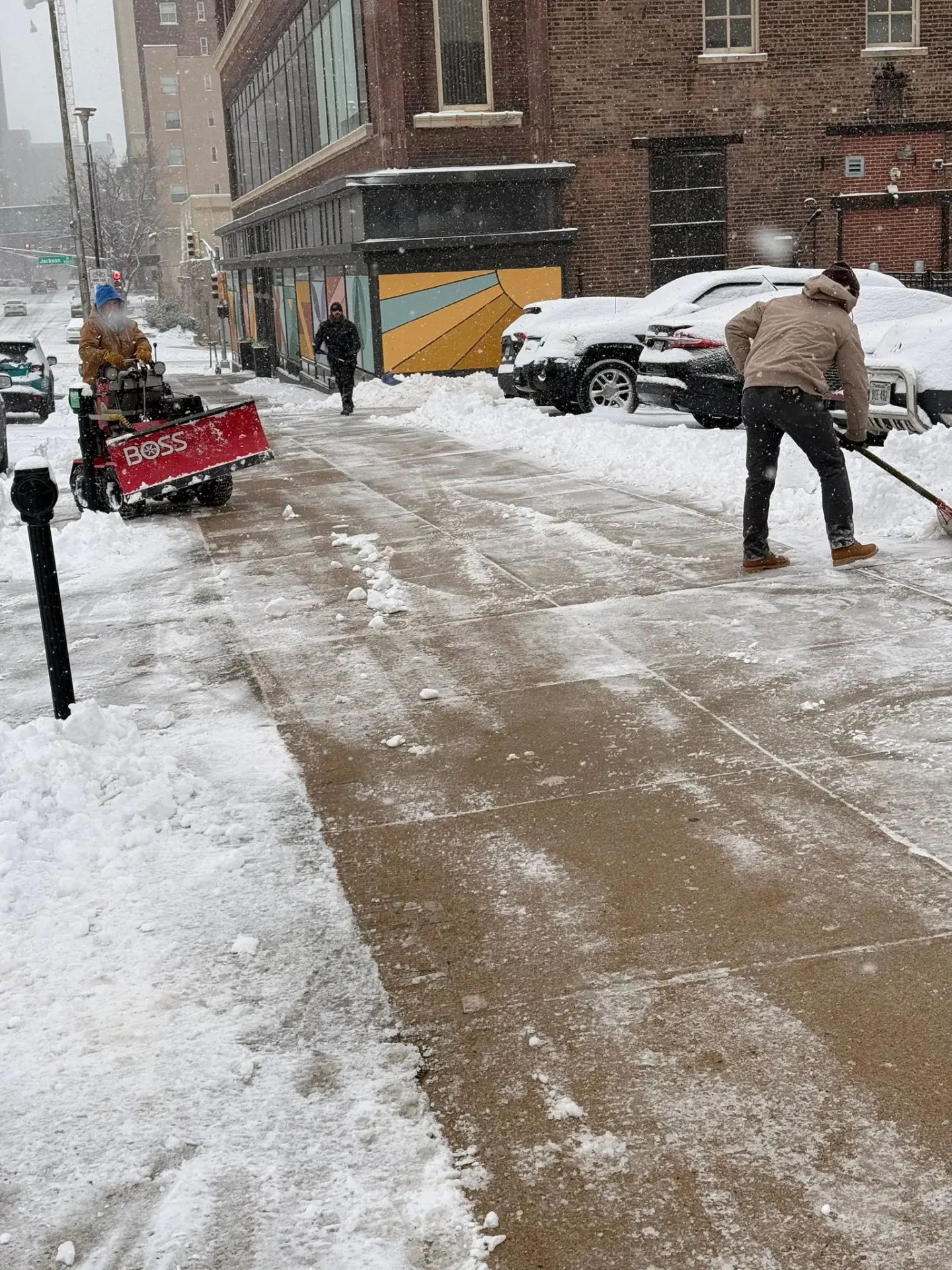 Snow plow clearing a commercial parking lot